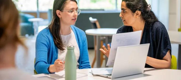 Student sat talking to a tutor 